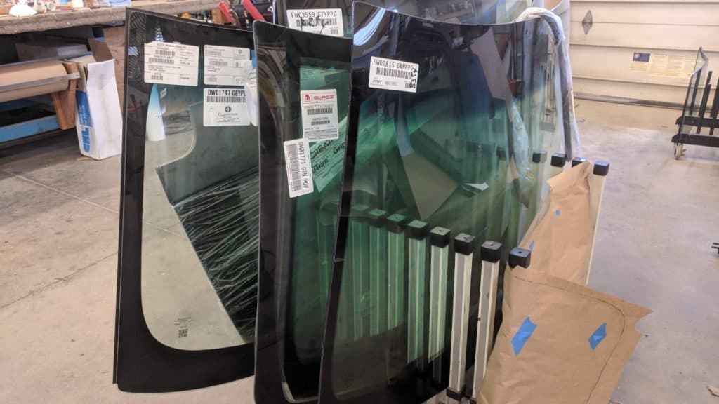 photo of automotive windshields in a rack